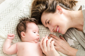 Portrait Of Happy Mother And Cute Newborn Baby Girl