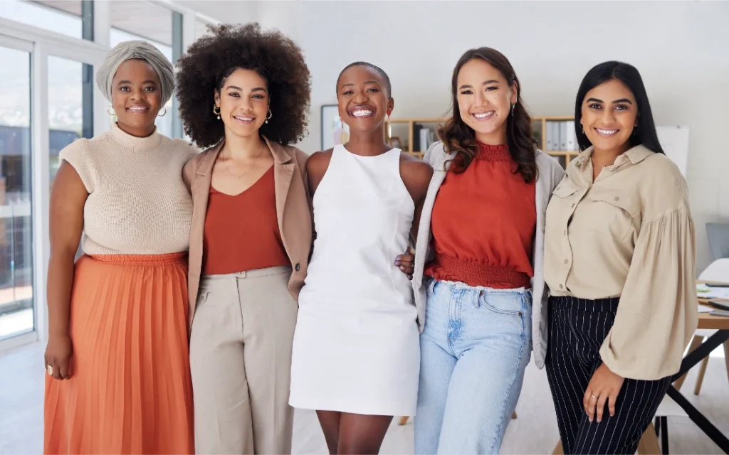 Diverse group of smiling business women standing together